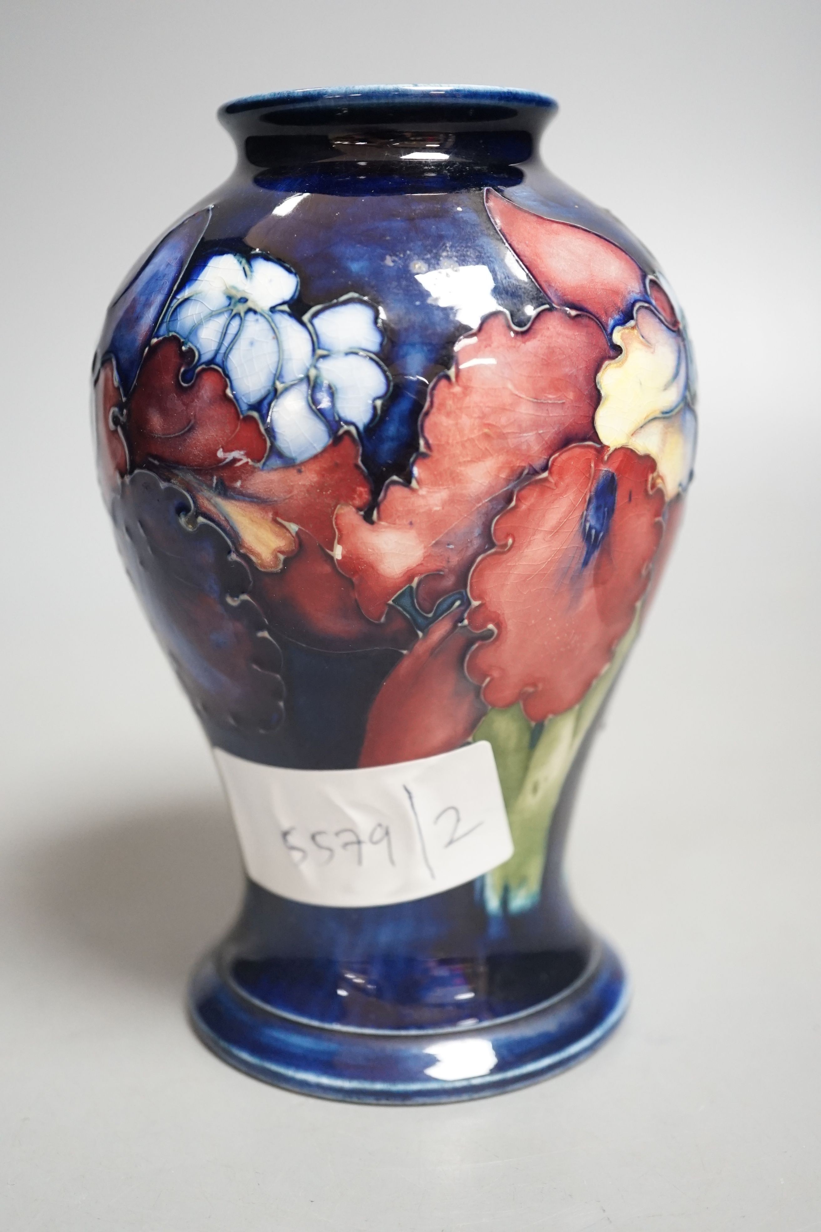 A Moorcroft orchid pattern vase - 15cm tall